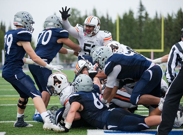 Bubba Mendoza is at the bottom of the pile with the winning score for West, which broke Soldotna's 59-game win streak with an 18-13 win.