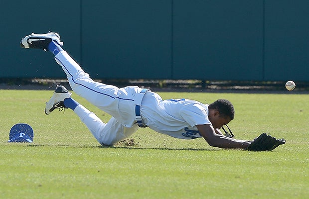 A Jesuit (Tampa, Fla.) centerfielder makes a diving attempt during a junior varsity game against IMG Academy.