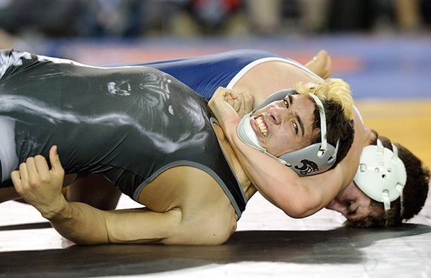 Bonney Lake (Wash.) wrestler Zach Koeller avoids a pin by Brett Allred of Everett in the first round of the 152-pound weight class at the WIAA state championships.