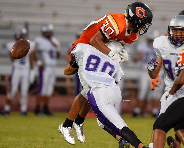 A Cesar Chavez (Ariz.) player hits a Corona del Sol punt returner to force a fumble during a junior varsity game.