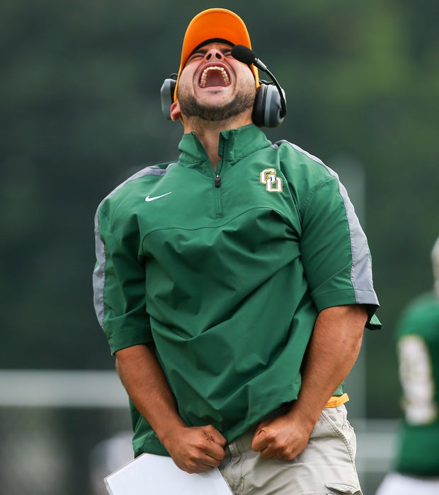 A Greece Olympia/Greece Odyssey (N.Y.) coach celebrates a touchdown during a football game against Greece Athena.