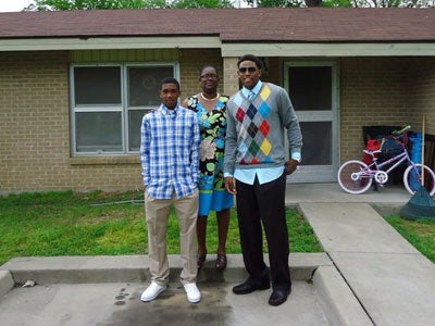 Malik (left) and his brother Marcus pose with their mother Jackie on
Easter 2011 in front of their former home in Lepanto.
