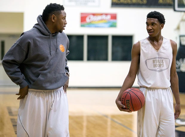 Malik chats with his older brother, Marcus, during a recent practice at Bentonville High School. His big brother plays a huge role in his life.