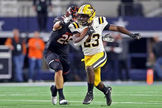 Marshall running back Jerry Davis (23) is corralled by Wyatt Harris. 