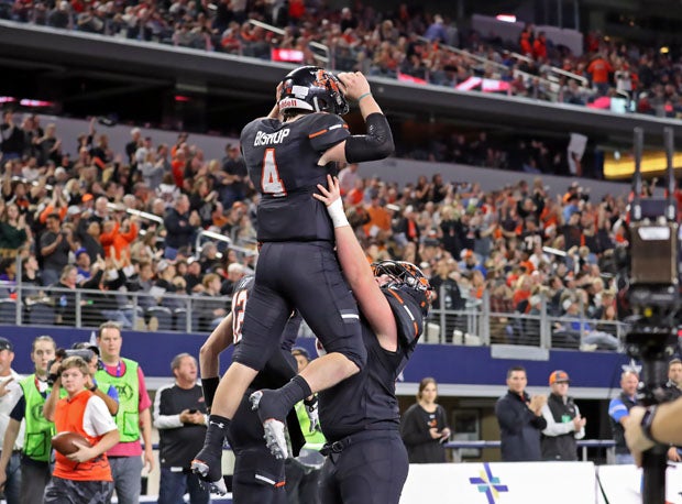 Jake Bishop (4) gets lifted into the air after scoring a second-half touchdown.