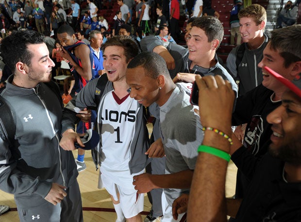 Johnnie Vassar is mobbed by teammates and fellow competitors after his final dunk.