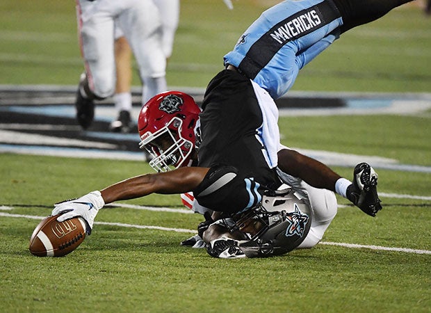 Fort Smith Southside (Ark.) receiver Desmond Lopez-Fulbright maintains control of the ball while flipping upside down  against Northside in August.