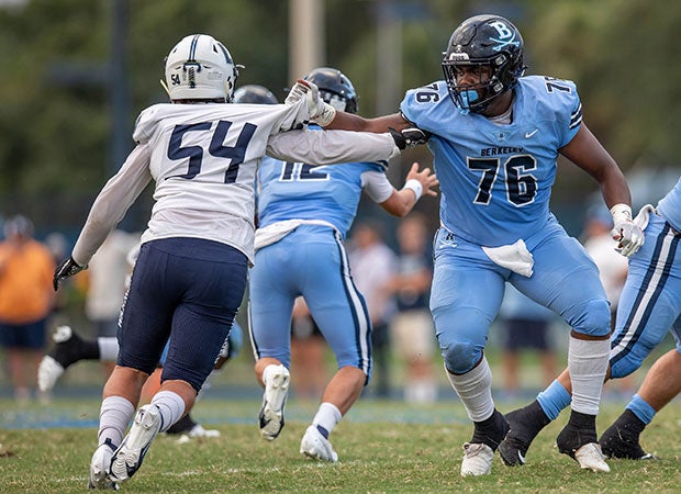 Berkeley Prep (Fla.) guard Nikhil Jefferson grabs the jersey of Calvary Christian defensive lineman Ryan Crossan in September.
