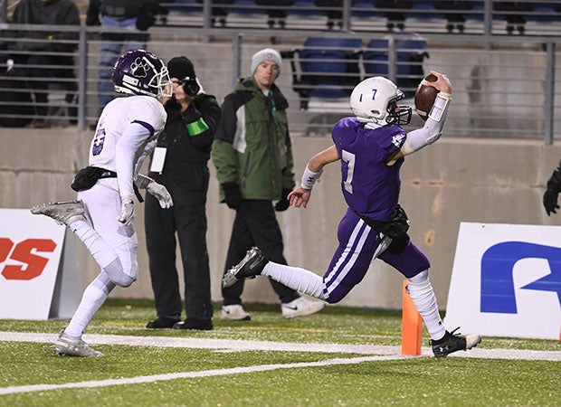 Elder quarterback Matthew Luebbe scores his team's first touchdown on a run during the first half.