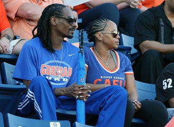 Snoop Dogg - Calvin Broadus - and his wife Shante
Broadus watch their son Cordell warm up before
Friday's game.