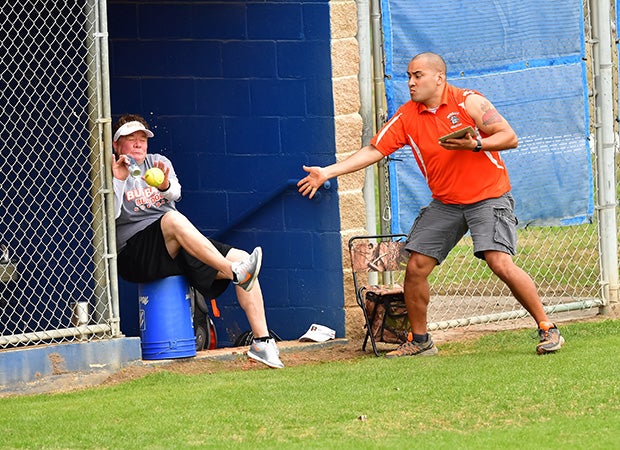 A Burbank (Texas) coach attempts to avoid a foul ball that hit him in the dugout.