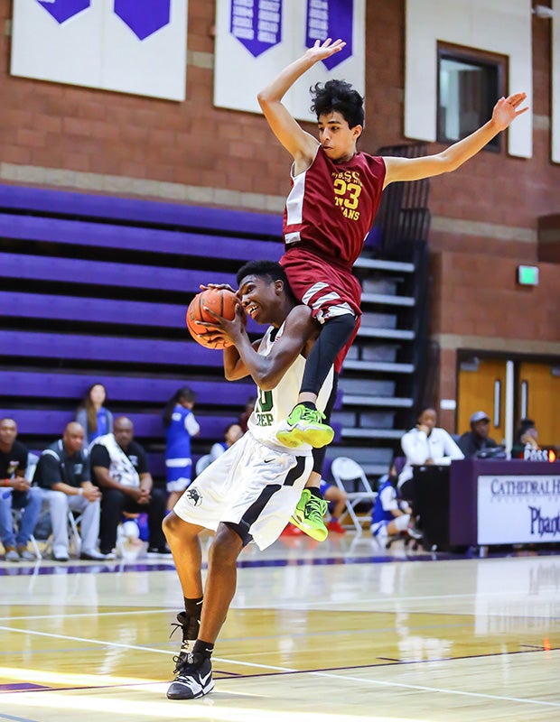 Guard Keith Eleby of Executive Prep Academy of Finance (Calif.) is fouled by USC Hybrid's Matthew Corna.