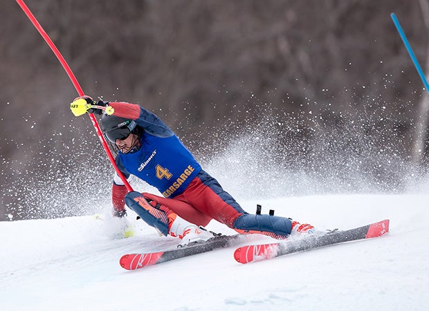 Aiden Markoff of Kearsarge Regional High School (N.H.) carves a hard turn while competing in the slalom on Mount Sunapee. 