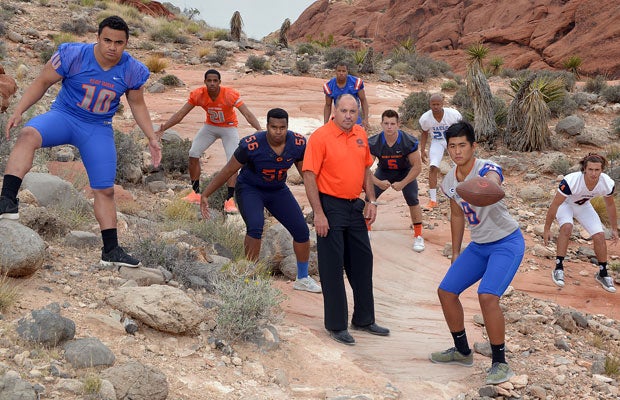 Head coach Tony Sanchez (center) and several top players pose for a photo shoot at the Red Rock Canyon National Conservation Area.