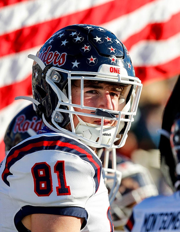 Denton Ryan (Texas) receiver Keagan Cunningham's helmet of stars is displayed in front of an American flag before the kickoff of their UIL 5A Division 1 Regional playoff game. 