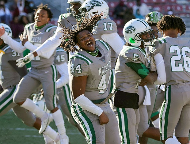 A Miami Central (Fla.) player celebrates with his teammates following their victory in the FHSAA 6A state championship game.