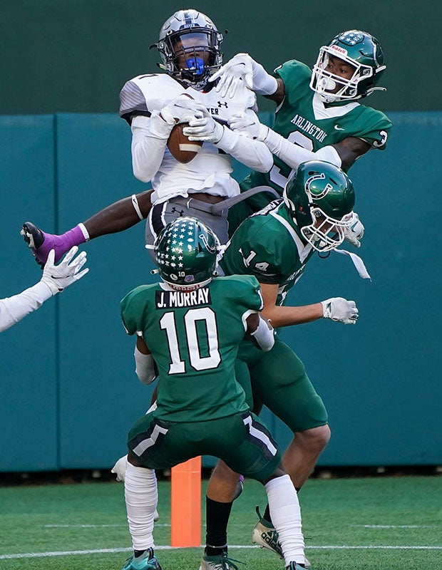 Receiver Jaden Fuggett of Denton Guyer (Texas) pulls down a Hail Mary pass for a touchdown among several Arlington defenders during a UIL 6A Division 2 Area playoff game.