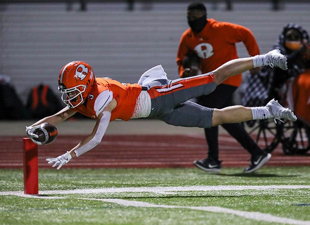 Receiver Jaxon Johnson of Rockwall (Texas) dives into the end zone for a touchdown during a UIL 6A Division 1 Bi-District playoff game.