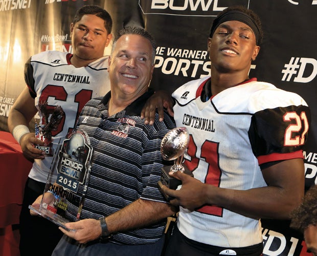 Head coach Matt Logan (center) celebrates with players (left to right) Paula Hafoka and J.J. Taylor following the game.