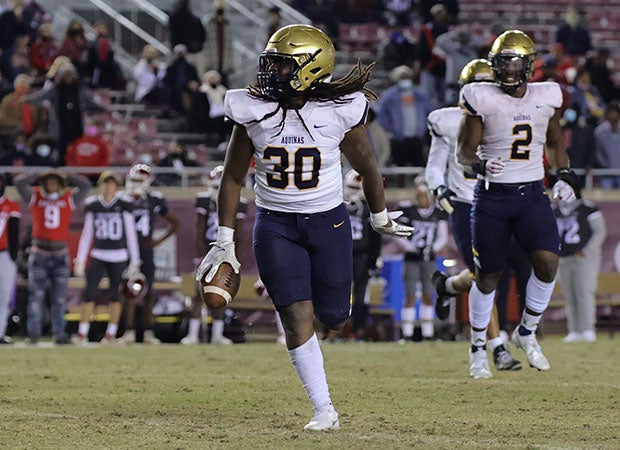 Aquinas linebacker Derrieon Craig celebrates one of his two fumble recoveries.