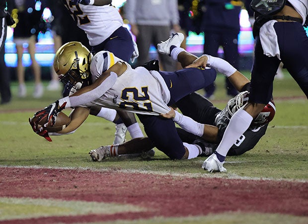 Anthony Hankerson with one of his two first-half touchdown runs for St. Thomas Aquinas.