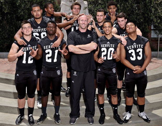 Several top Servite players have fun with head coach A.J. Gass (center) during a photo shoot.