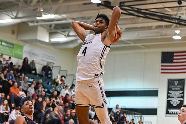 Greg Brown III rises for a dunk against Cedar Ridge in January.
