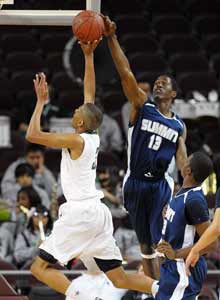 Summit's Cameron Lewis goes high
to block a shot.