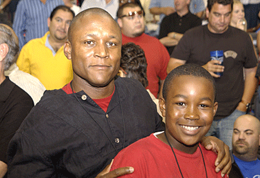 Retired NFL running back Barry Sanders and his son, Barry Jr., attend game five of the 2005 NBA Finals.
