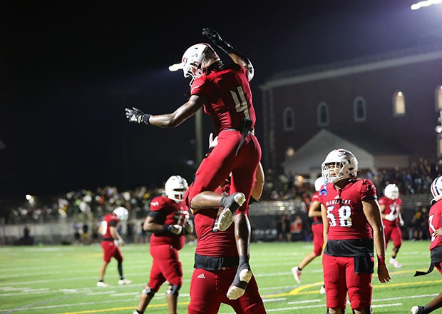 A Chaminade-Madonna teammate celebrates Jeremiah Smith's second touchdown of the night in the Lions' 28-16 win over American Heritage. (Photo: Laura Martin)