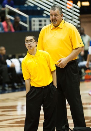 Lucas Cortez (front) in normal attire as
Bishop O'Dowd student manager. On Friday
he turned into super manager, changed
into a uniform and sank a 3-pointer.