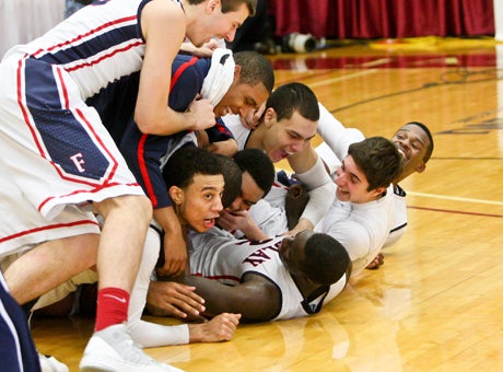 Nigel Williams-Goss is dog-piled after making his game-winning shot against Montverde Academy. 