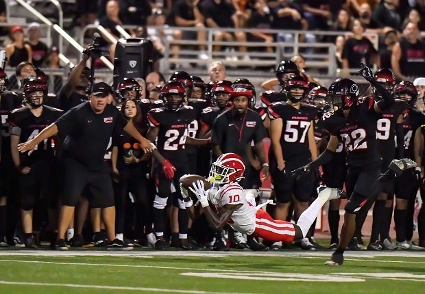 Marcus Harris makes a diving catch on a pass from junior quarterback Elijah Brown during the Monarchs' big win over Corona Centennial on Friday.