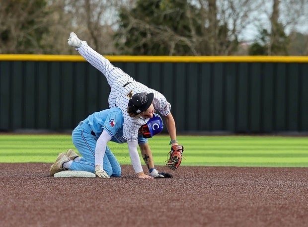 Crandall second baseman Brayson Moore is upended while attempting to turn a double play against Burleson Centennial.(Photo: Robbie Rakestraw)
