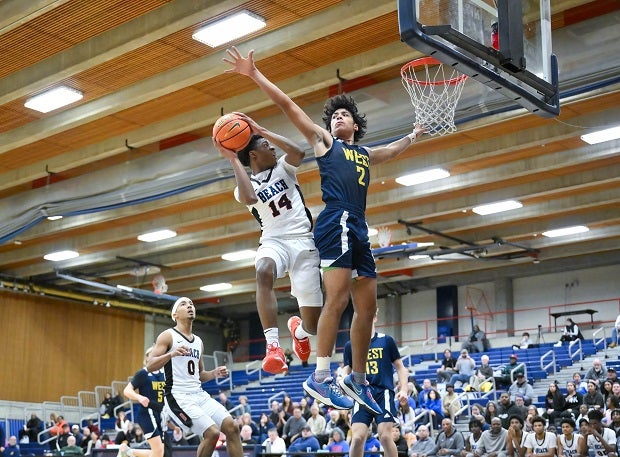 Rainier Beach freshman Patrice Mpouli and West Seattle senior Maximus Holliman battle in the paint as both teams chase Washington State postseason dreams.(Photo: Patrick Krohn)