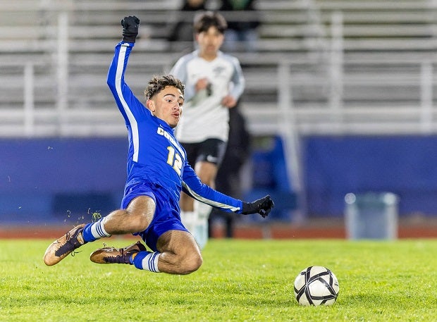 Newark Memorial Junior Armando Rodriguez flies in mid-air looking to take down an opponent in a slide tackle. (Photo: Jennifer Meure)