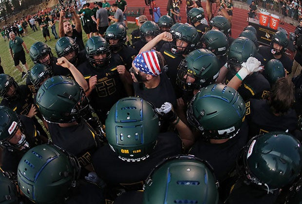 The Paradise football team huddles shortly before its first home game since the Camp Fire on Aug. 23.