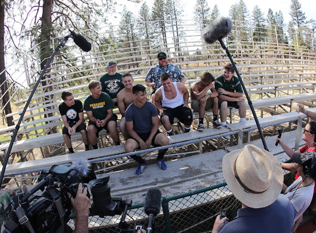 Andy Hopper (back row right) offers levity during a makeshift press conference for Paradise the day before its season opener.