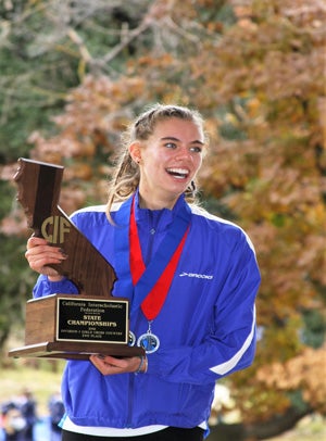 O'Keeffe holding Davis' second-place trophy at
the state cross country meet in Fresno.