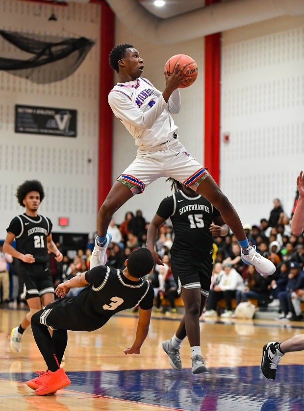 Senior Felton Gray of New York's Monroe drives hard to the basket and looks to finish against Rochester's School of the Arts. (Photo: Dennis Joyce)