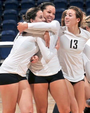 Rachel Williams (center) of Archbishop Mitty celebrates
a state championship with Brittany Bozzini (13) and
Joan Caloiaro (left).