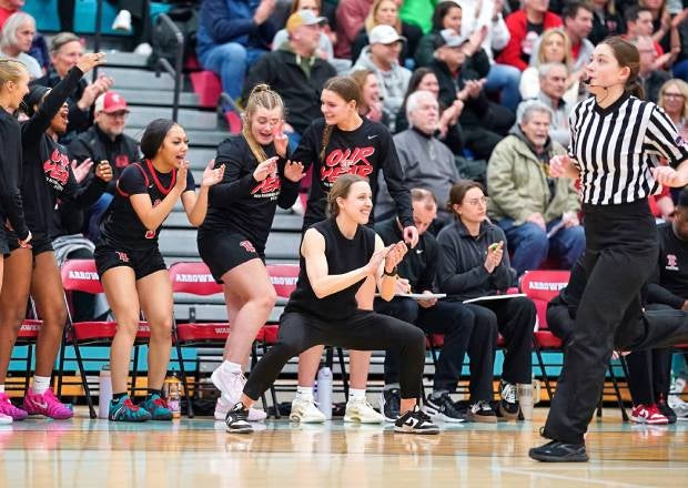 Wauwatosa East head coach Mary Merg celebrates during the Red Raiders' 76-66 overtime win against Arrowhead last week. Merg guided Tosa East to the Division 2 state championship last season. (PHOTO: David Feyen)