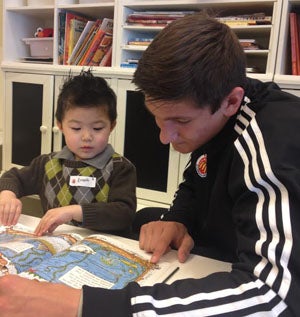 Grayson Allen reads to a young guest at the 
Ronald McDonald House in Chicago, the largest 
RMH in the world. Allen attends Providence 
in Jacksonville (Fla.) and will 
attend Duke. 