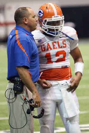 Sanchez confers with sophomore QB Jarrett Solomon.