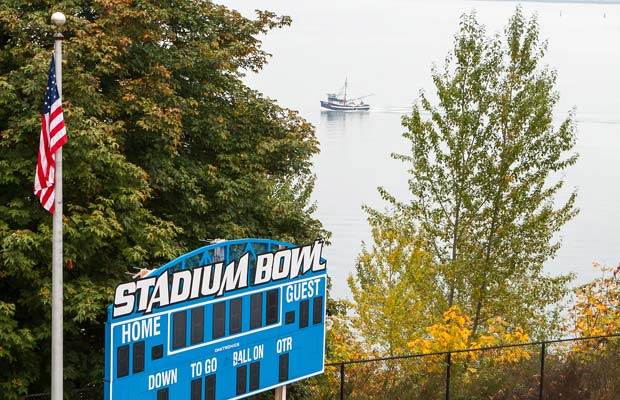 A fishing boat passes by on Commencement Bay behind the north end zone.