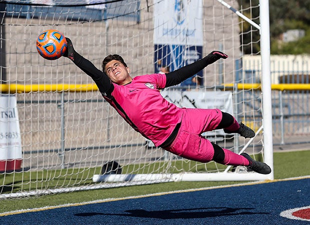 Walden Grove (Ariz.) goalkeeper Ethan Itule makes a diving save en route to a 3-0 victory over Prescott in an AIA 4A state semifinal game.