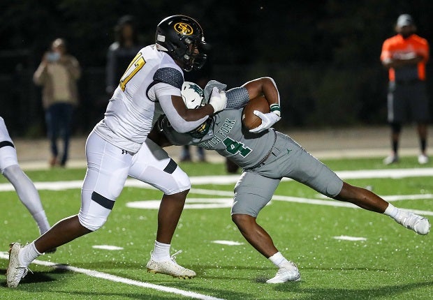 St. Frances Academy defensive end Brian Simms III (17) wraps up Dutch Fork running back Jarvis Green in first half action. The St. Frances defense was stout, holding the Dutch Fork offense out of the end zone in a xx-xx victory.