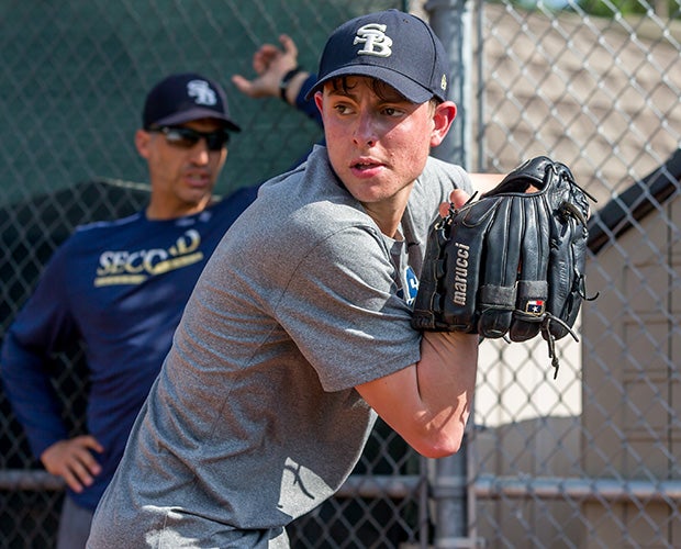 Former MLB pitcher and five-time World Series champion Andy Pettitte looks on as Ryan throws during a practice session.