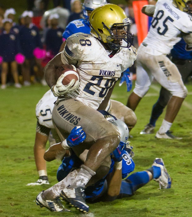 Running back Tavien Feaster attempts to elude a diving Byrnes defender. Feaster had a scoring run for the Vikings.