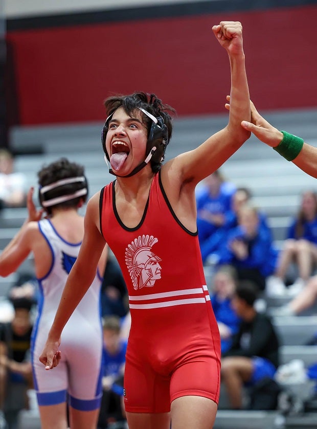 A Park Hill junior varsity wrestler celebrates his victory over an opponent from Liberty. (Photo: David Smith)